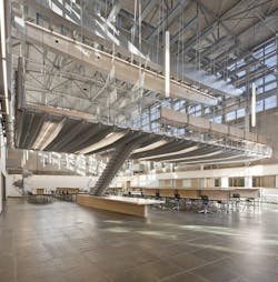 Dubbed The Hammock by students, the hanging mezzanine was created by repurposing a large bridge crane to support a tapered flo Dubbed The Hammock by students, the hanging mezzanine was created by repurposing a large bridge crane to support a tapered flo
