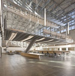 Dubbed The Hammock by students, the hanging mezzanine was created by repurposing a large bridge crane to support a tapered flo Dubbed The Hammock by students, the hanging mezzanine was created by repurposing a large bridge crane to support a tapered flo