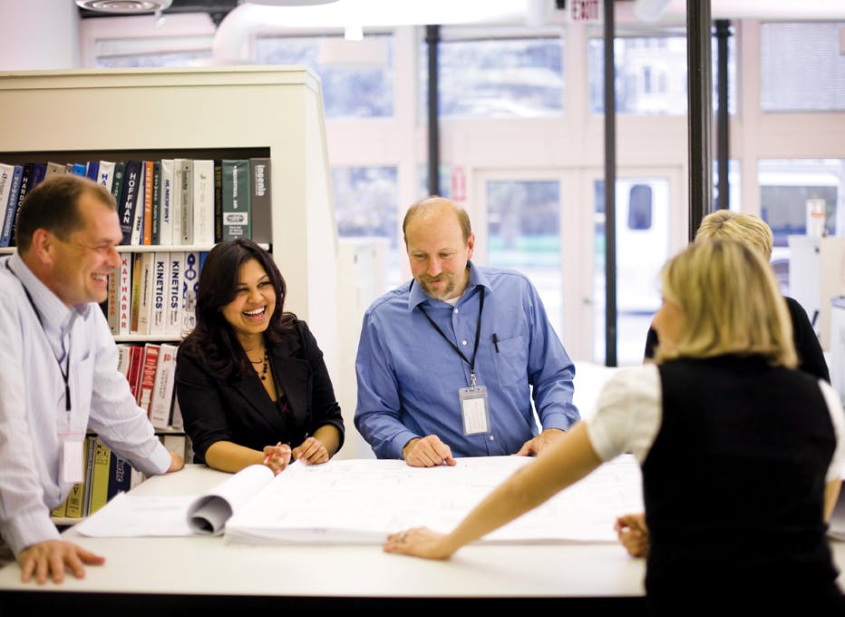 EYP Architecture & Engineering designers review drawings for a historic preservation project. The firms in-house education foru