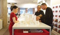 Members of Genslers San Francisco office collaborate around a model of a project. The firms culture values learning, professio Members of Genslers San Francisco office collaborate around a model of a project. The firms culture values learning, professio