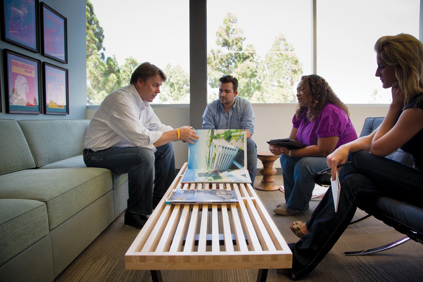 Randy Peterson, President of HMC Architects, confers with colleagues Billy Chundak, Jeannette Warren, and Alicia Strom on a proj