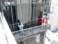 Workers repair a failed glass curtain wall. As glazed curtain walls age, many of their components may reach the end of their se Workers repair a failed glass curtain wall. As glazed curtain walls age, many of their components may reach the end of their se