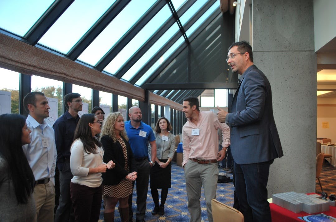 Tom Wujec, Autodesk Fellow and Lead Facilitator for the U40 Vision Competition, talks with some of the winning teams before thei