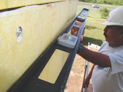 To true the wall surface, the installer should level the insulation board, rather than build up the base coat. Checking stud ali To true the wall surface, the installer should level the insulation board, rather than build up the base coat. Checking stud ali