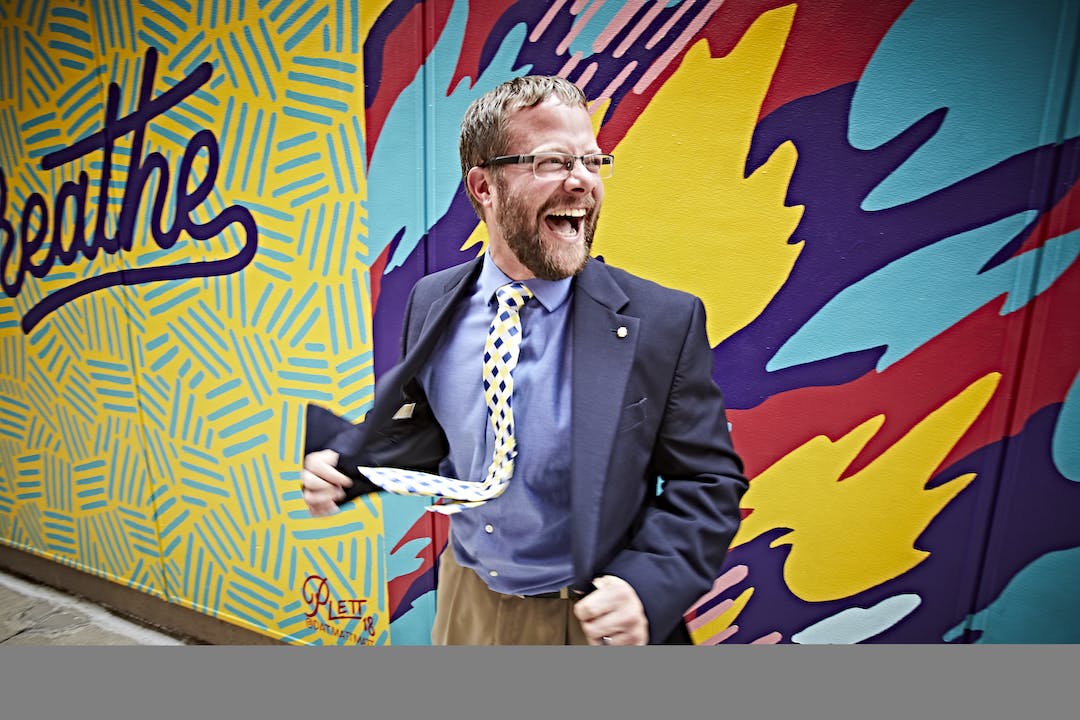 Under 40 philanthropist in front of mural