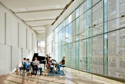 Engaging with the surrounding urban environment, the building features glass curtain walls along Broadway, providing views of th Engaging with the surrounding urban environment, the building features glass curtain walls along Broadway, providing views of th