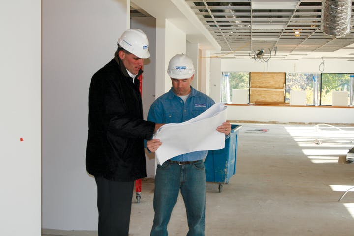 Chapman Construction/Design professionals on the job. Commercial interiors make up 80% of its work. Nearly half the firms staff