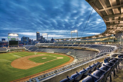 Variegated brick at the street level, brushed aluminum, and a mixture of clear and translucent glass surround the top of the sta