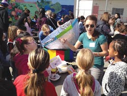 A Cal Poly Pomona student helps children at Santa Monicas McKinley Elementary School work a solar cooker, developed with HMC vo A Cal Poly Pomona student helps children at Santa Monicas McKinley Elementary School work a solar cooker, developed with HMC vo