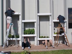 HMC volunteers install planters in a vertical garden wall at the Second Harvest Food Bank, in New Orleans. HMC employees and its HMC volunteers install planters in a vertical garden wall at the Second Harvest Food Bank, in New Orleans. HMC employees and its