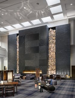 A ceiling-high stone fireplace framed by rustic wooden logs was created by artisans for the Hyatt Regency Minneapolis. Elsewhere A ceiling-high stone fireplace framed by rustic wooden logs was created by artisans for the Hyatt Regency Minneapolis. Elsewhere