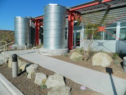 A single-slope metal roof supports an efficient rainwater harvesting system. Twelve galvanized steel cistern tanks gather water A single-slope metal roof supports an efficient rainwater harvesting system. Twelve galvanized steel cistern tanks gather water