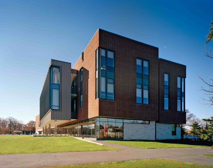 Through the use of sand cast red brick, oak doors, and a warm natural color palette, the building maintains a strong connection