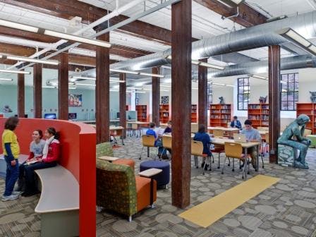 The interior design includes carpet with 65% recycled content, light fixtures reused from the existing building, and natural lig