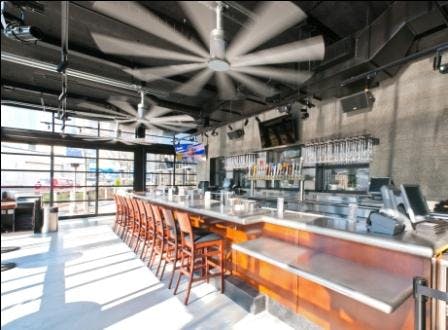 Garage Doors Surround The Four Season Patio, Which Also Features Large Stainless Steel Fans Hung From The Ceiling