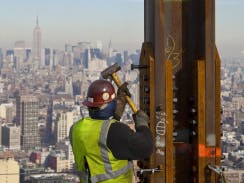 Construction crews set in place a steel horizontal beam at a height of about 1,270 feet, topping by about 20 feet th(C) CBS News