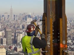 Construction crews set in place a steel horizontal beam at a height of about 1,270 feet, topping by about 20 feet th(C) CBS News Construction crews set in place a steel horizontal beam at a height of about 1,270 feet, topping by about 20 feet th(C) CBS News