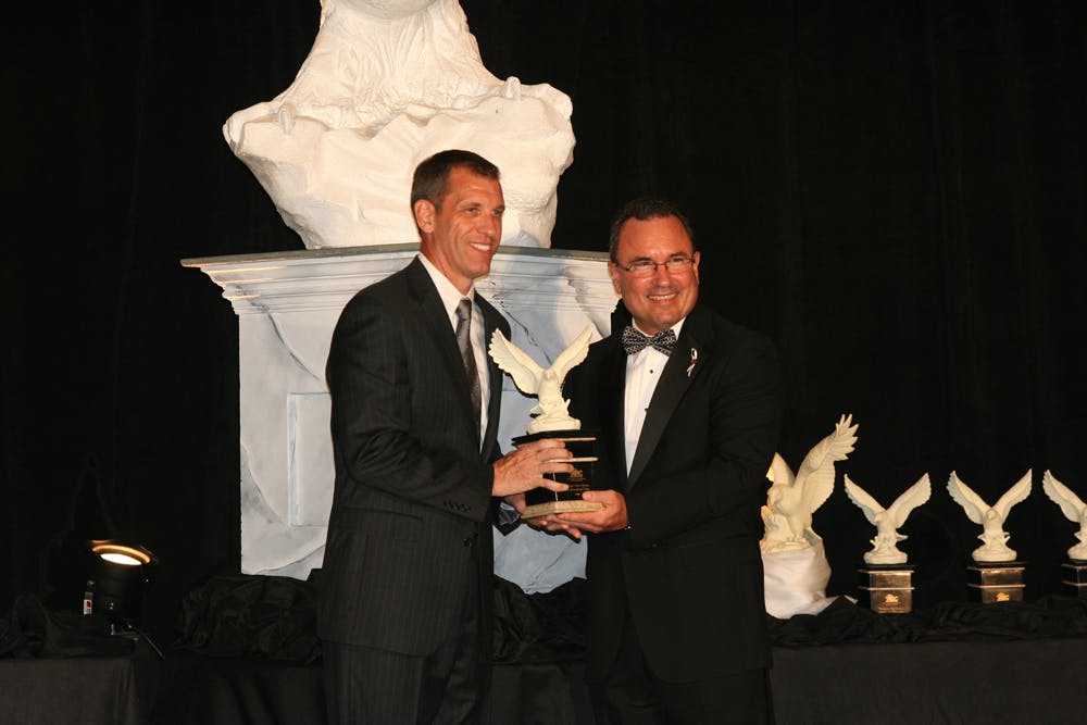 Dwyn Taylor (eft), Vice President Of Stellar, Accepts An Award At The Abc Ceremony