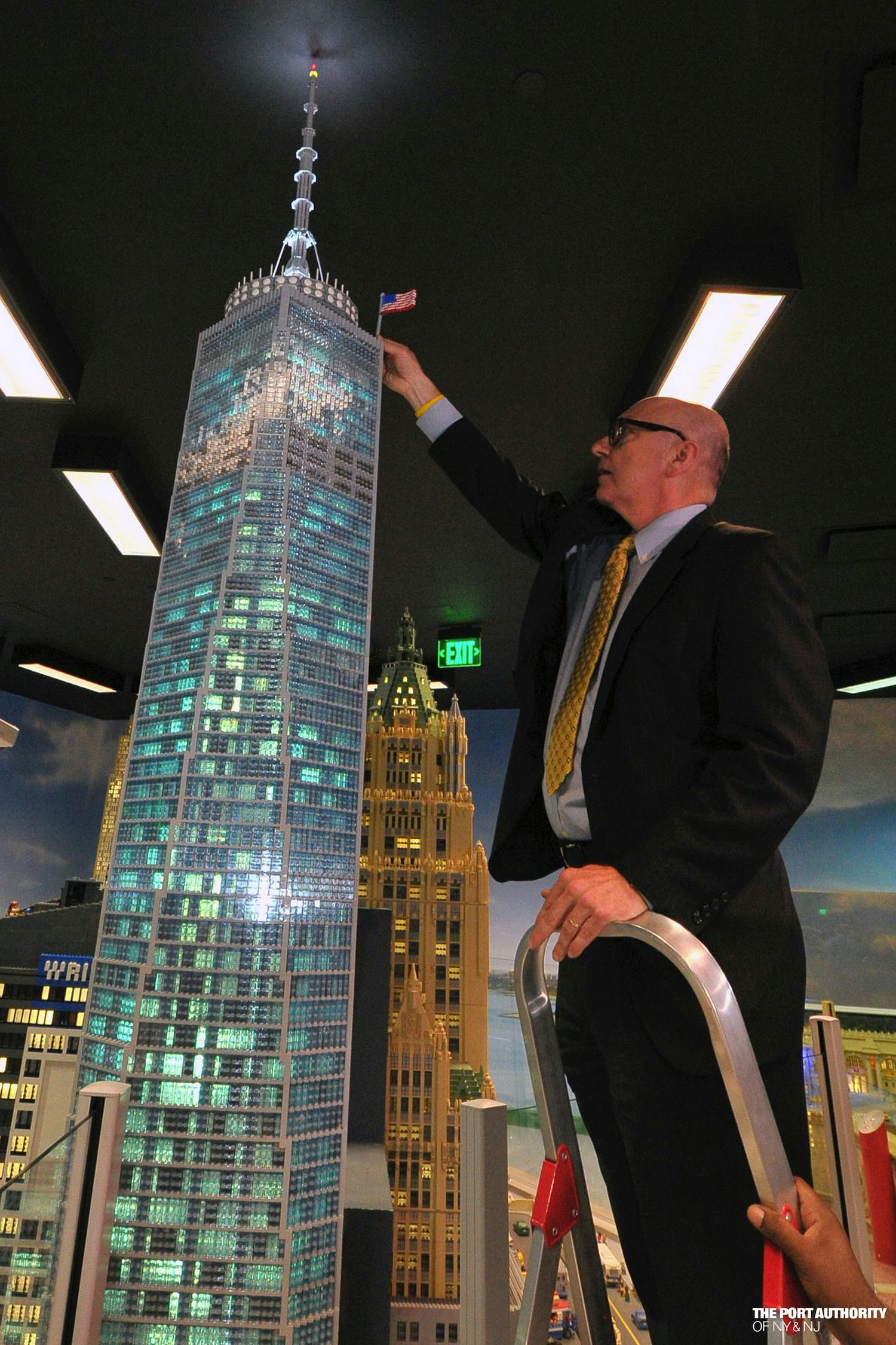 Steve Plate, Director of World Trade Center Construction places a LEGO US Flag on a LEGO replica of One World Trade Center during the model's unveiling at LEGOLAND Discovery Center Westchester on June 28, 2013. (Photo Credit: Port Authority/ Mike Dombrowski)