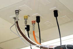 Vacuum network tubing (white) plumbed through ceiling tile Vacuum network tubing (white) plumbed through ceiling tile