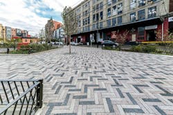 Three Colors Of Permeable Plank Pavers Are Laid In A Herringbone Pattern At A Park Featuring Garden Beds And Trees Three Colors Of Permeable Plank Pavers Are Laid In A Herringbone Pattern At A Park Featuring Garden Beds And Trees