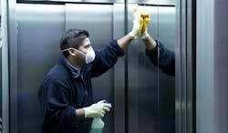 coronavirus. cleaning staff disinfecting elevator to avoid contagion coronavirus. cleaning staff disinfecting elevator to avoid contagion