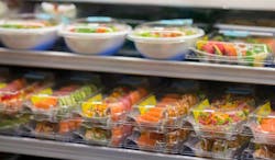 Fresh sushi for sale at a supermarket deli in togo containers Fresh sushi for sale at a supermarket deli in togo containers