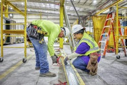 A certified supervisor overseeing employee during construction A certified supervisor overseeing employee during construction