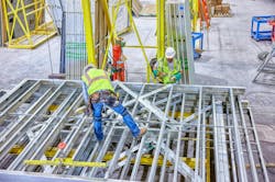 Load-bearing units and two workers in offsite construction factory Load-bearing units and two workers in offsite construction factory