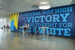 High school student in front of mural on campus High school student in front of mural on campus