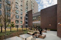 Students sitting in the rooftop garden of the DREAM Charter School affordable housing Students sitting in the rooftop garden of the DREAM Charter School affordable housing