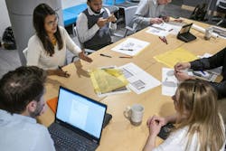 Office workers planning around a table Office workers planning around a table