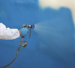 A worker spraying Sopraseal LM 204 VP on a wall A worker spraying Sopraseal LM 204 VP on a wall