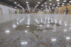 A puddle of water on a concrete floor treated with Concrete Protector SB A puddle of water on a concrete floor treated with Concrete Protector SB