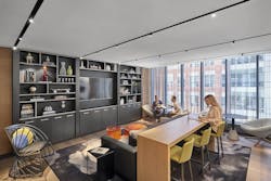 Proto's third floor lounge with three people sitting in it Proto's third floor lounge with three people sitting in it