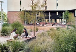 Residence hall exterior students studying Residence hall exterior students studying