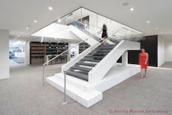 The tile and glass staircase that connects the two floors The tile and glass staircase that connects the two floors