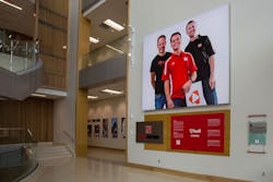 Greeting visitors upon entry in the Henrickson Grand Atrium is a 14-foot tall display featuring the founders of HUDL Greeting visitors upon entry in the Henrickson Grand Atrium is a 14-foot tall display featuring the founders of HUDL