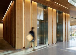 Student walks passed Douglas fir cladding in LSB Student walks passed Douglas fir cladding in LSB