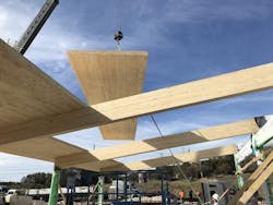 Crane lowering CLT panel into place Crane lowering CLT panel into place