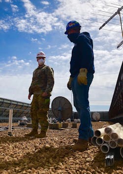 Workers inspect rooftop units in support of ensuring healthy air circulation in the facility Workers inspect rooftop units in support of ensuring healthy air circulation in the facility