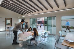 Kennedy Middle School Administration/Family Center interior with students drawing Kennedy Middle School Administration/Family Center interior with students drawing