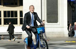 Jason Dubowski riding bike in suit Jason Dubowski riding bike in suit