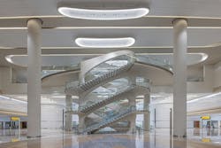 View of the Arrivals Hall Feature Staircase at Zayed International Airport, Terminal A. Photo: Victor Romero, courtesy Kohn Pedersen Fox (KPF) View of the Arrivals Hall Feature Staircase at Zayed International Airport, Terminal A. Photo: Victor Romero, courtesy Kohn Pedersen Fox (KPF)