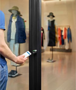 Man using wireless key access to enter a retail store Man using wireless key access to enter a retail store