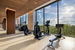 Wellness amenities at the One High Line development include a 75-foot lap pool with cabanas, fitness studio (pictured) with private training rooms, steam rooms and saunas, and a private treatment room. Wellness amenities at the One High Line development include a 75-foot lap pool with cabanas, fitness studio (pictured) with private training rooms, steam rooms and saunas, and a private treatment room.