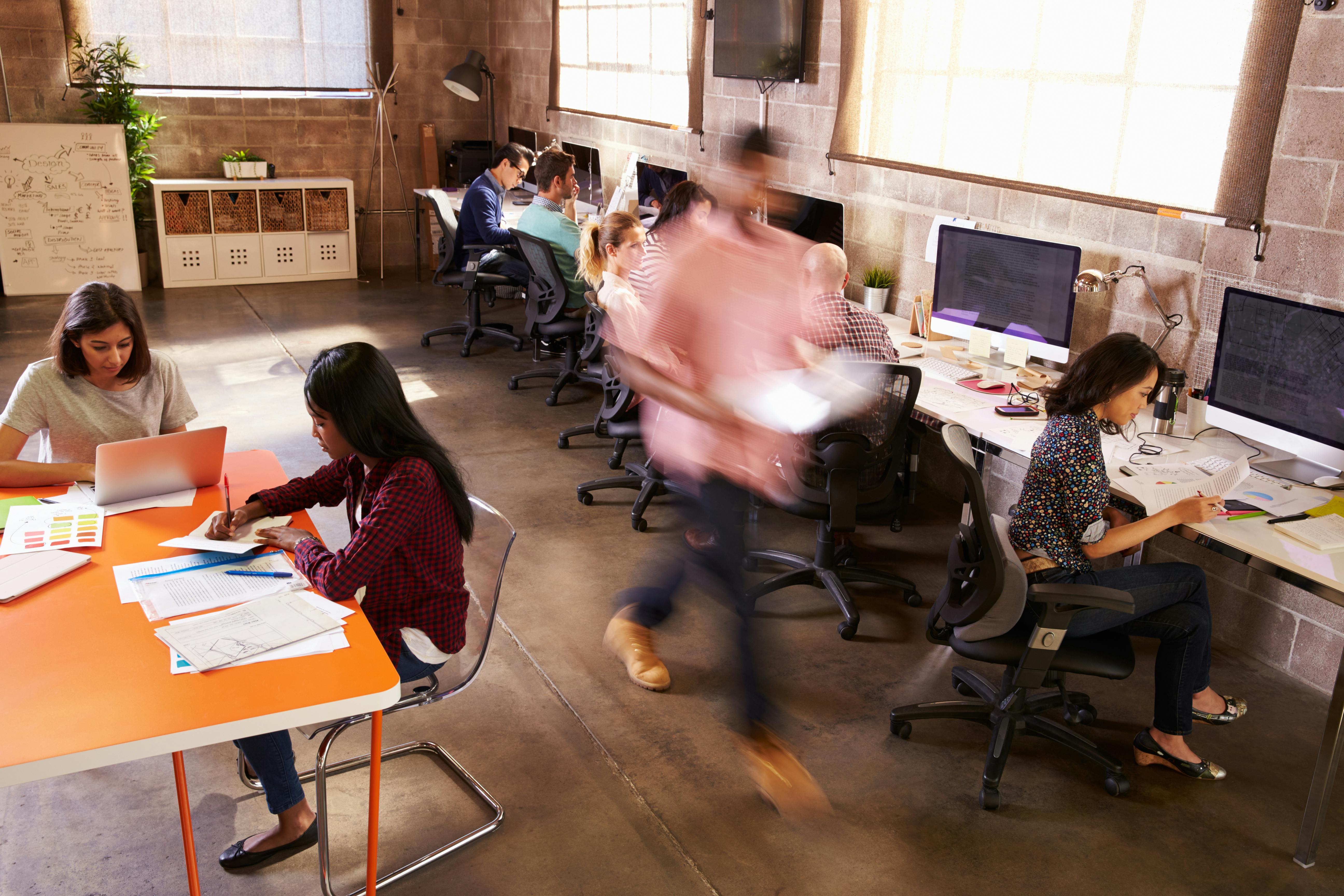 Elevated View Of Workers In Busy Modern Design Office