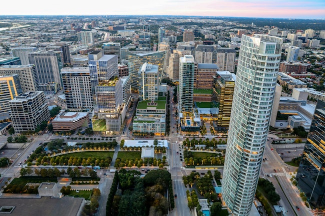 Pictured: Bank of America Tower at Parkside, Dallas, Texas. The Bank of America Tower at Parkside’s 30 stories feature a striking sculptural design, where transparent glass and landscaped terraces blend seamlessly with the park below, creating a visually dynamic experience