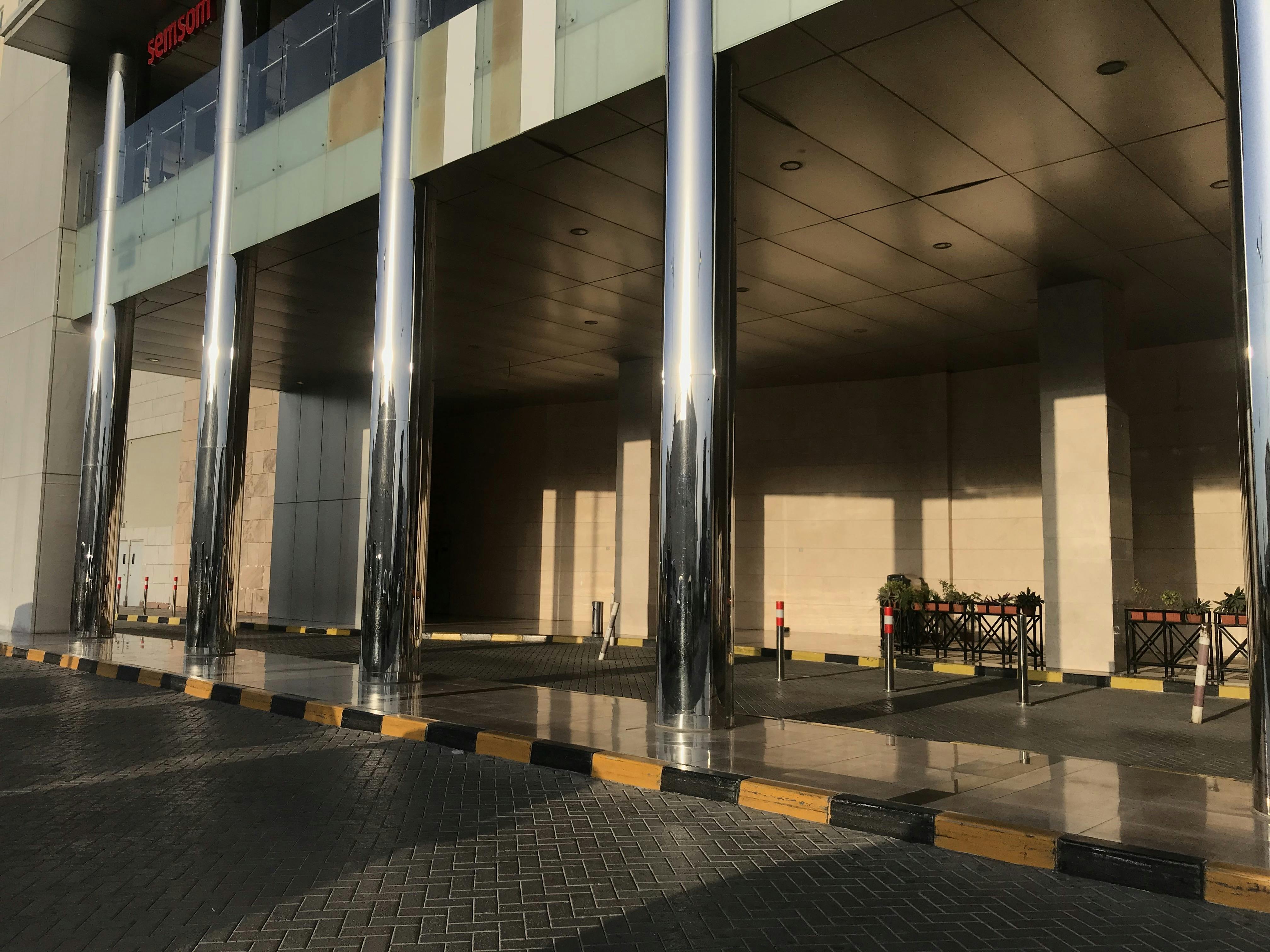 Concrete filled stainless steel finished tubular columns in an entrance of an Big shopping mall construction exterior finishes for an lucrative finishes