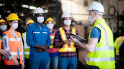 The manager or leader team is assignmenting a job for team of technicians, supervisor, foreman and engineers In the morning meeting before work In which everyone wear masks to prevent the coronavirus